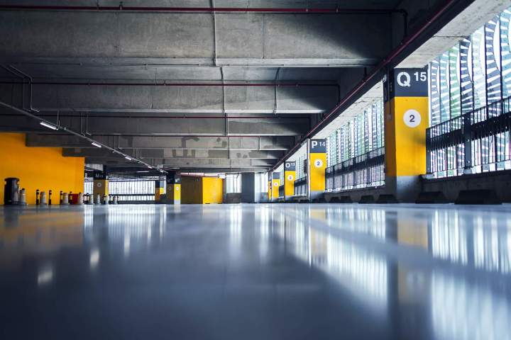 empty garage with parking lots with concrete ceiling flooring pillars marked with numbers